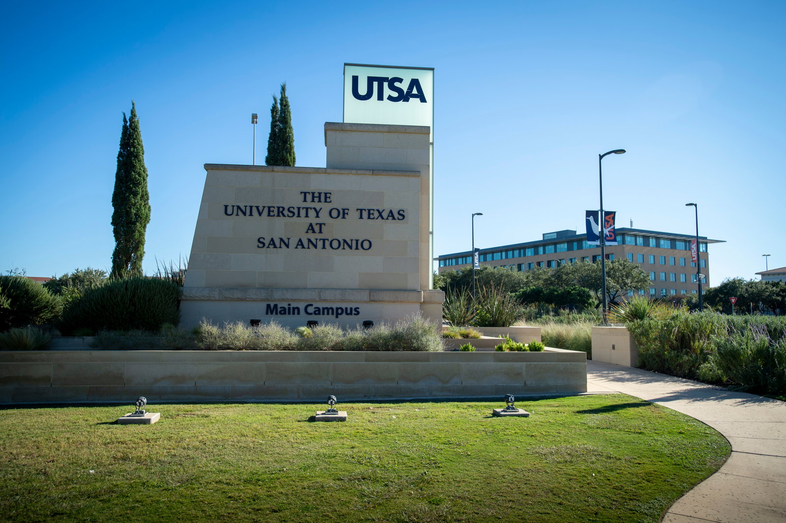 UT San Antonio entrance sign with the North Paseo Building in background